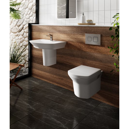 Bathroom with a wall-mounted sink and toilet against a wooden panel wall.